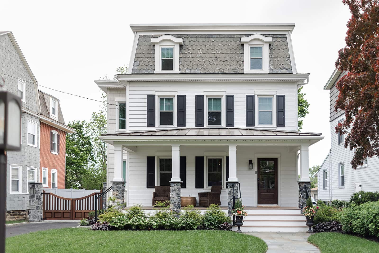 White two-story house exterior evaluated to build up or build out